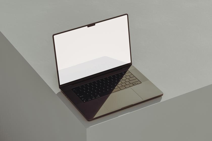 An open laptop on a grey cube.
