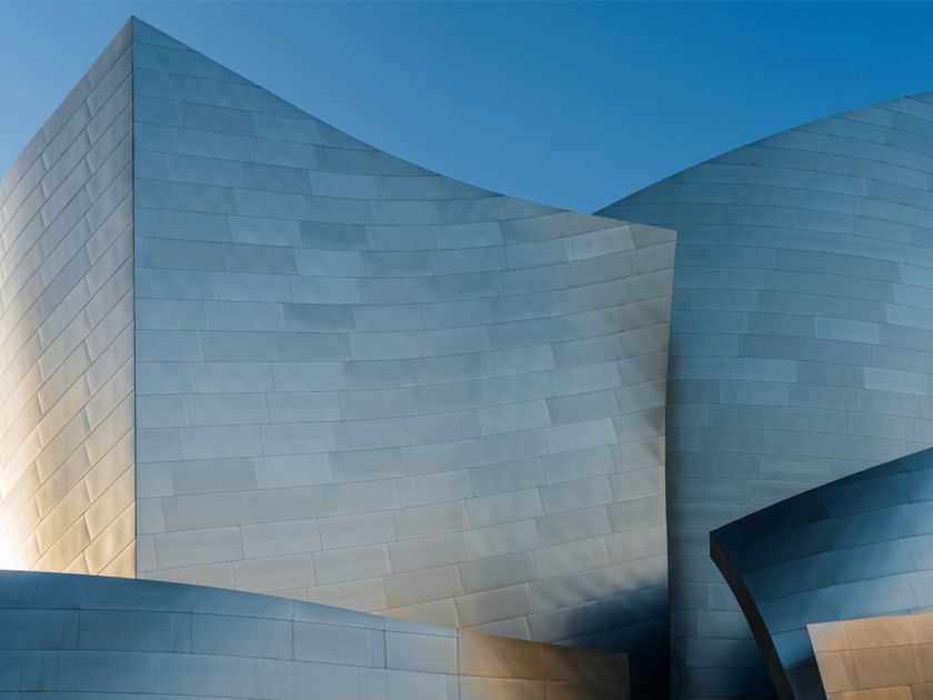 Contrasting architecture in grey with blue sky in the background.