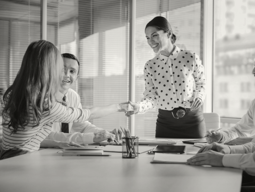 Black and white photo of a woman leading a team