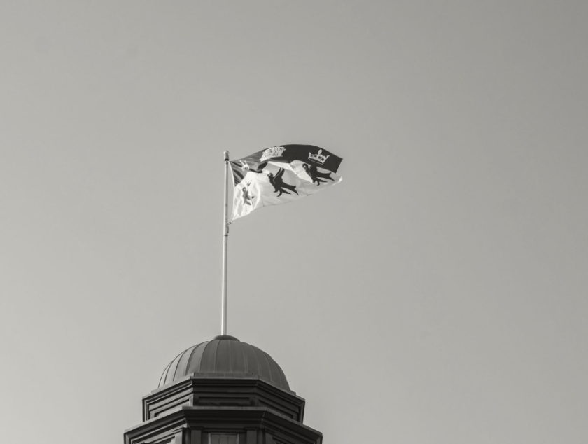 Black and white McGill Flag against the sky