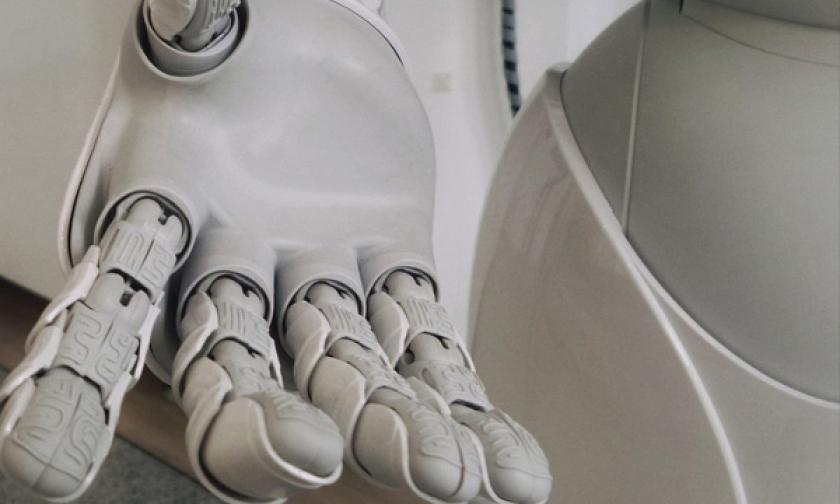 Robotic hand extending towards you symbolizing AI.
