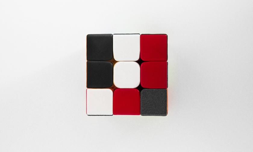 A black, white, and red rubik cube.