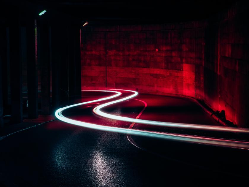 Long exposure lights with red background on a street
