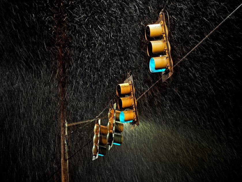 Green street lights with pouring rain