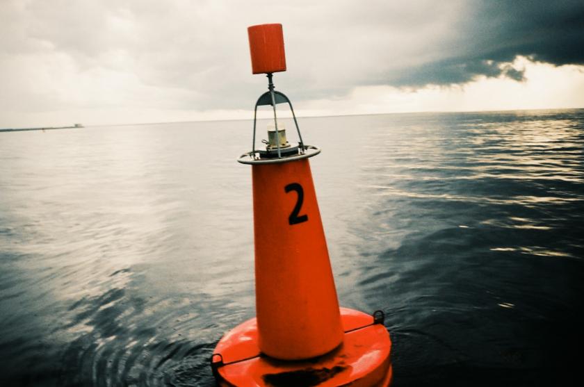 A buoy at sea with only the ocean in the background