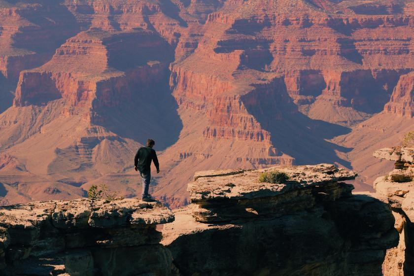 Man hiking alone and on top of the mountain.