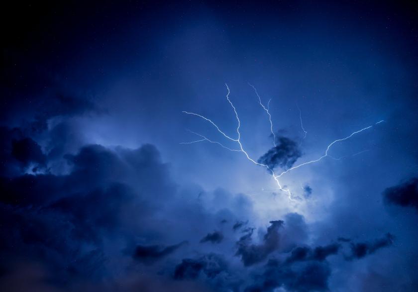 Blue sky with lightning spreading across the sky