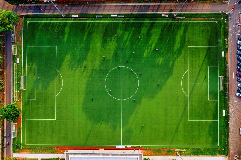 Green soccer field seen from birds eye view.
